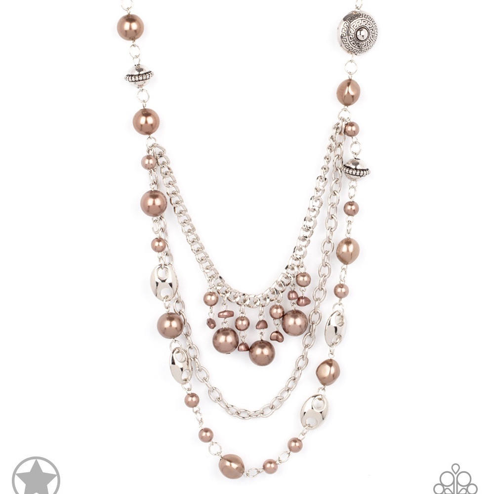 A silky brown ribbon replaces a traditional chain to give an elegant look.